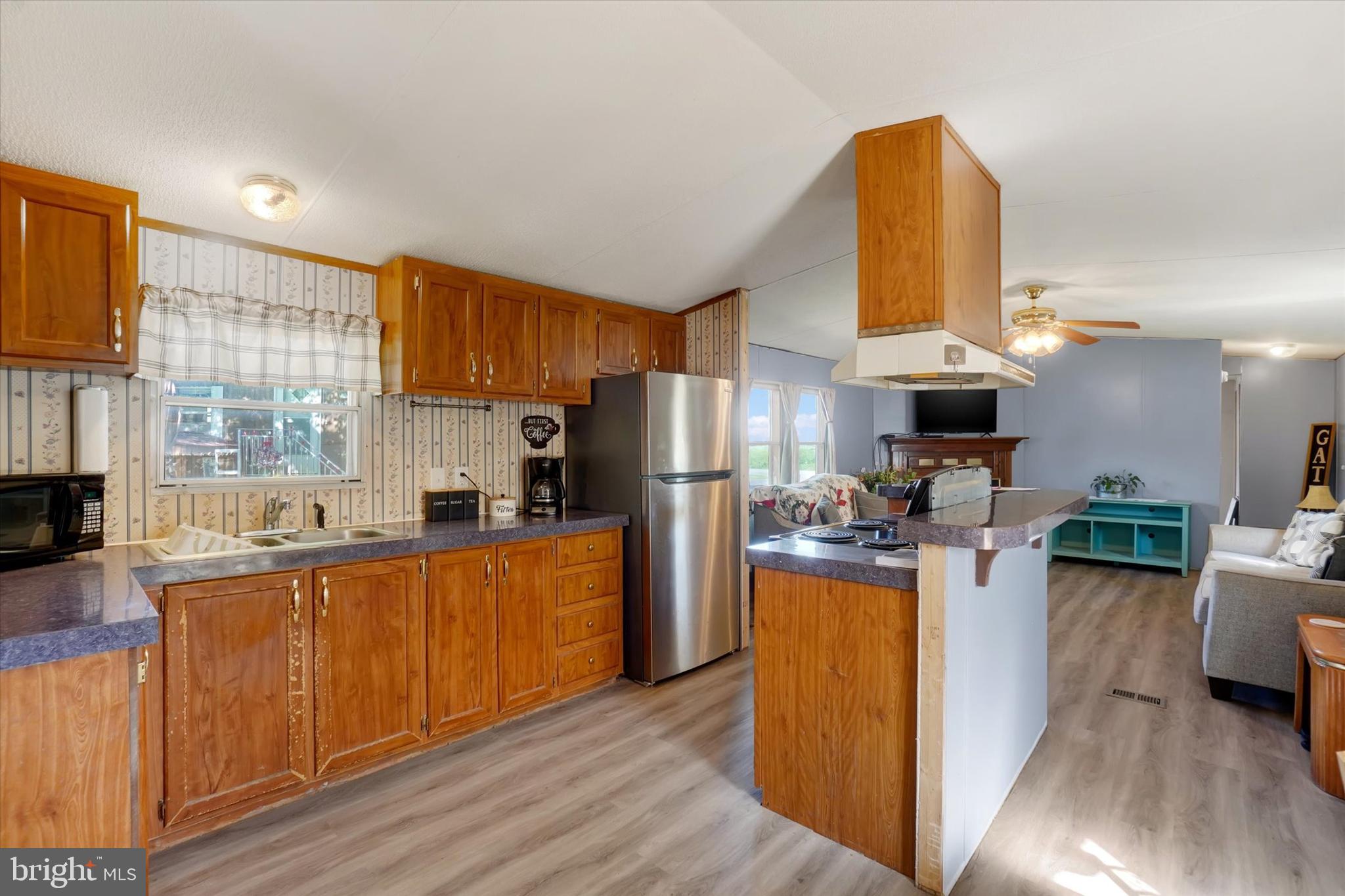 700 Salem Road Etters, PA 17319 - Photo 6 of 16 a kitchen with stainless steel appliances granite countertop a refrigerator a stove top oven a sink dishwasher and wooden cabinets with wooden floor