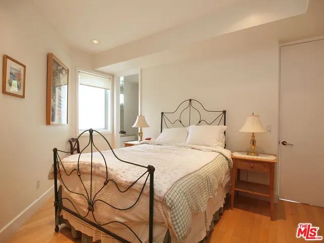 a bedroom with a bed and chair