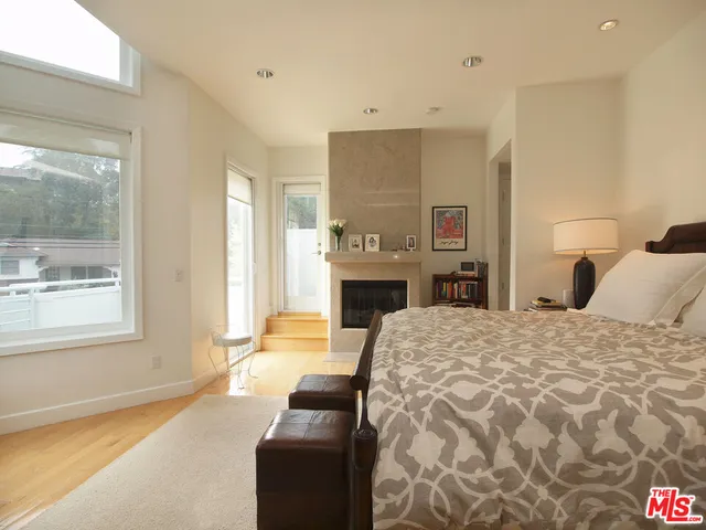 a bedroom with a bed and a fireplace