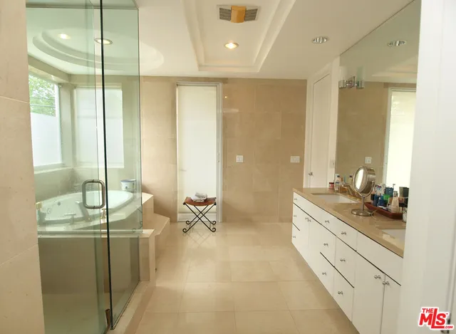 a spacious bathroom with double vanity and a bathtub