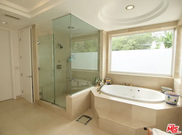a white bath tub sitting next to a bathroom sink