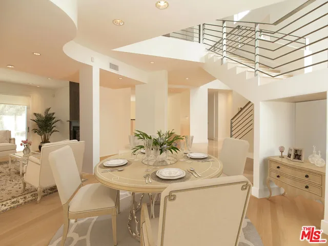 a view of a dining room with furniture and a chandelier
