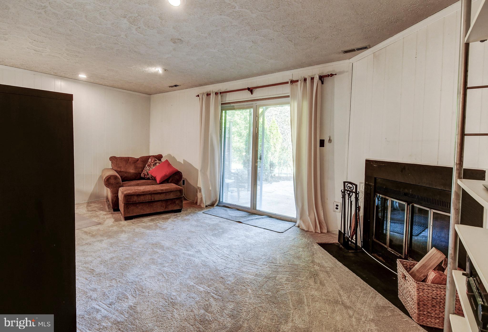 9247 Bellbeck Road Baltimore, MD 21234 - Photo 19 of 28 Wood burning fireplace and new sliders to walk out