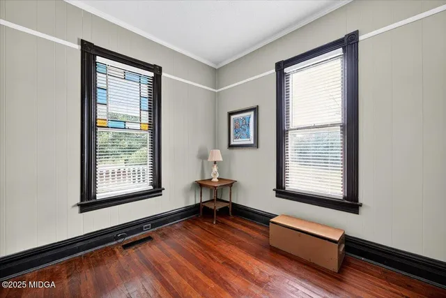 a living room with a bed furniture and a window