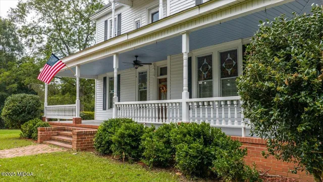 a view of a house with a yard and sitting area