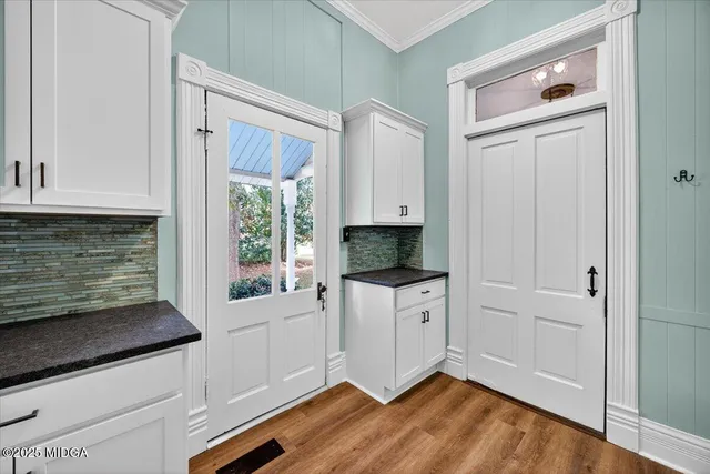 a view of a hallway with wooden floor and closet