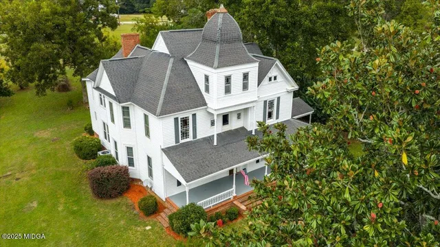 a aerial view of a house with swimming pool and garden