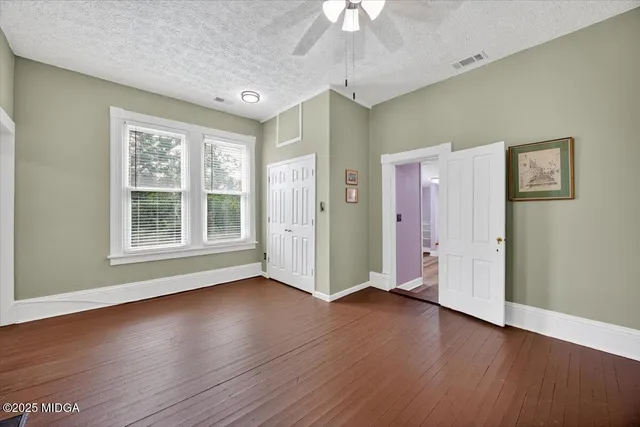an aerial view of a house with a garden and lake view
