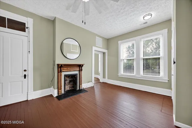 an aerial view of a house with a yard and lake view