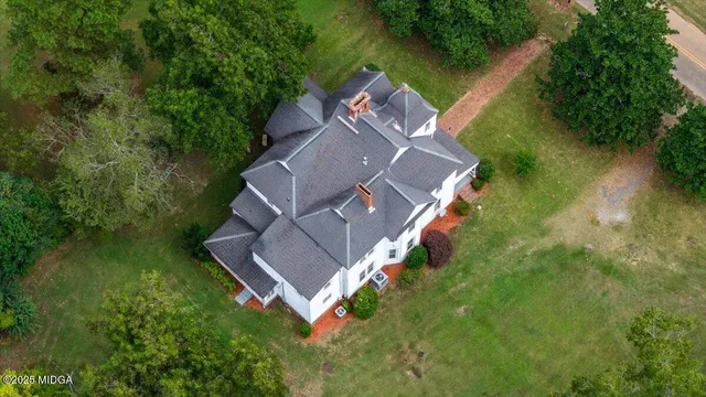 an aerial view of a house with a yard