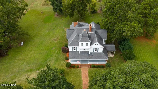 an aerial view of residential house with outdoor space and swimming pool