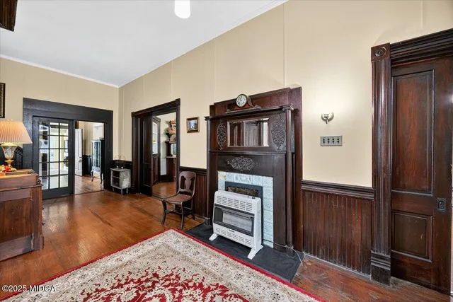 a living room with furniture a window and a flat screen tv