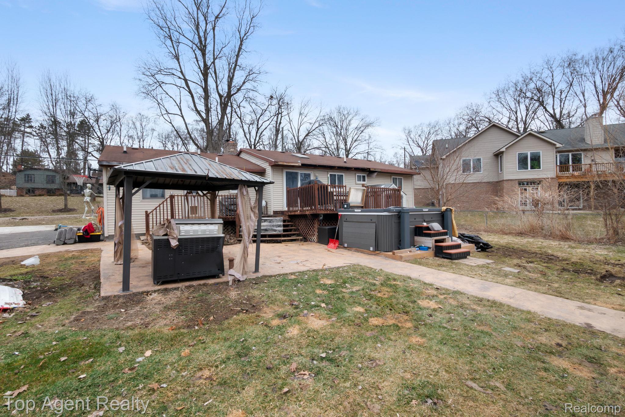 2065 Ridgemont Street Commerce Township, MI 48382 - Photo 31 of 35 View of green lawn featuring a hot tub, a gazebo, a wooden deck, and a patio area