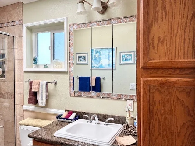 a kitchen with sink and mirror