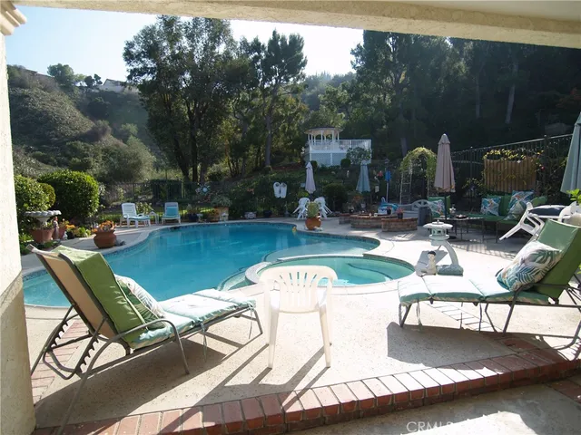 a view of a house with a yard and sitting area