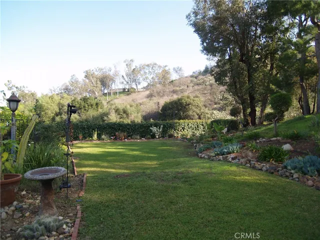 a view of a garden with an outdoor seating