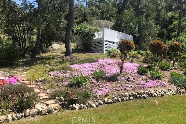 a backyard of a house with lots of green space and fountain