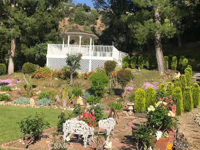a view of a house with a garden and lake view
