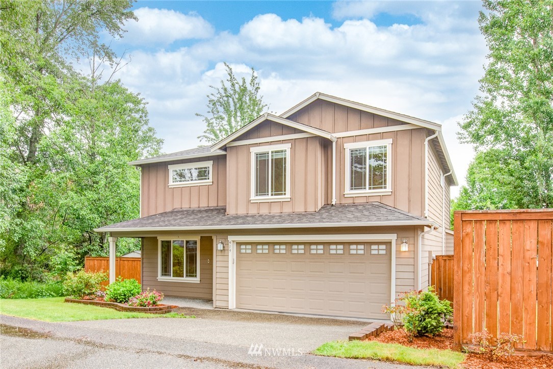 919 228th Street Southeast Bothell, WA 98021 - Photo 2 of 25 a front view of a house with a yard and garage