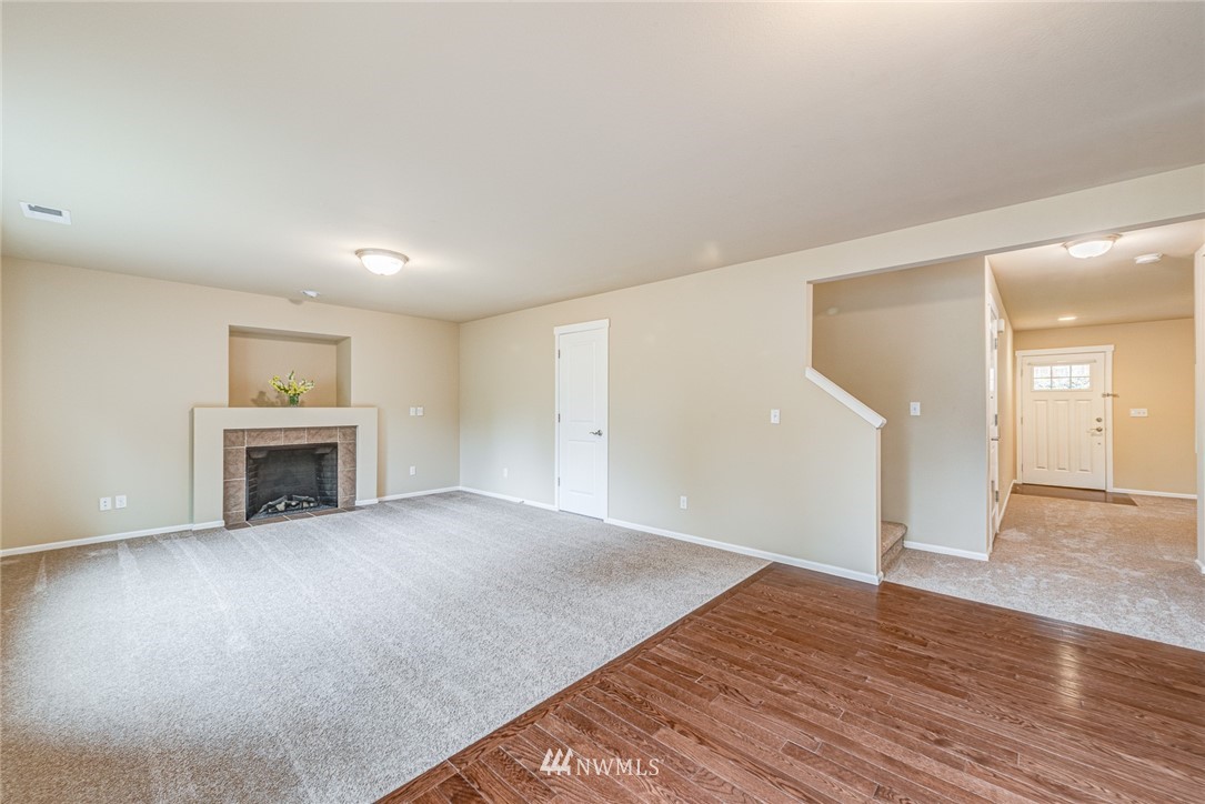 919 228th Street Southeast Bothell, WA 98021 - Photo 15 of 25 a view of an empty room with wooden floor and a fireplace
