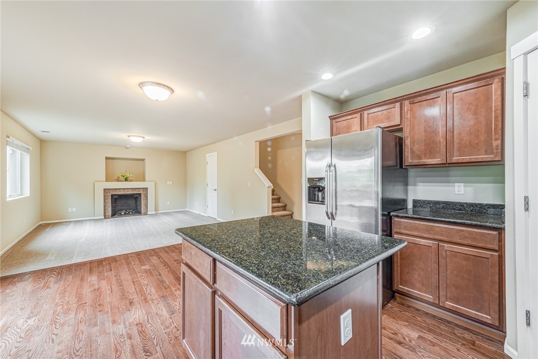 919 228th Street Southeast Bothell, WA 98021 - Photo 16 of 25 a kitchen with kitchen island a counter top space cabinets and stainless steel appliances
