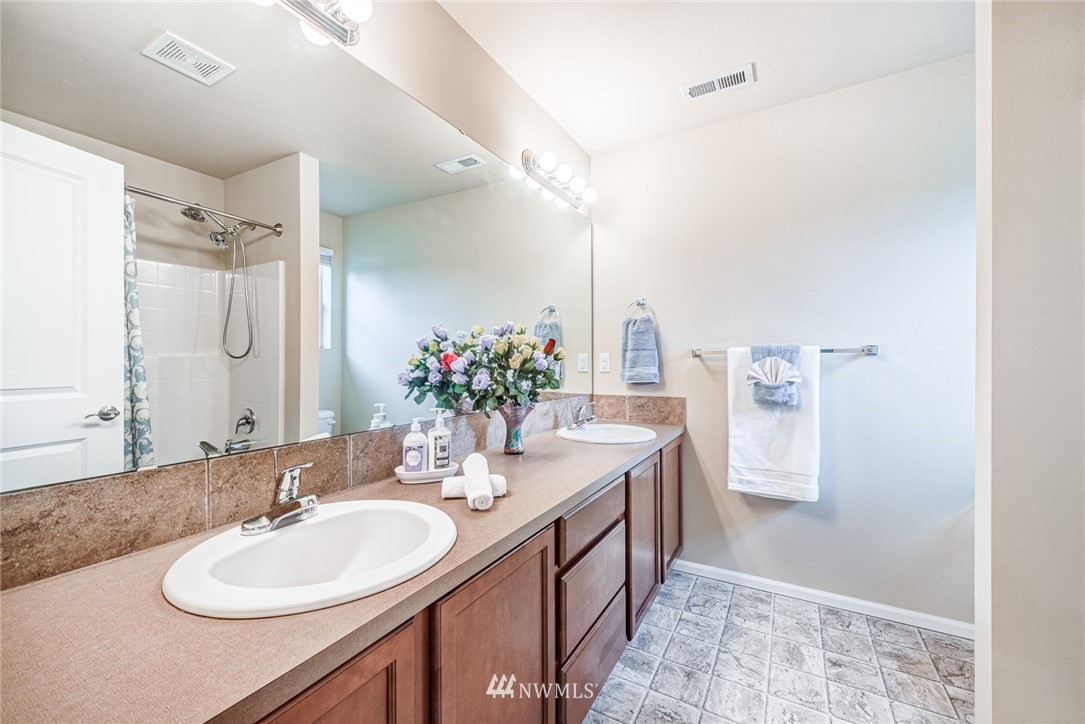 919 228th Street Southeast Bothell, WA 98021 - Photo 20 of 25 a bathroom with a double vanity sink and a mirror