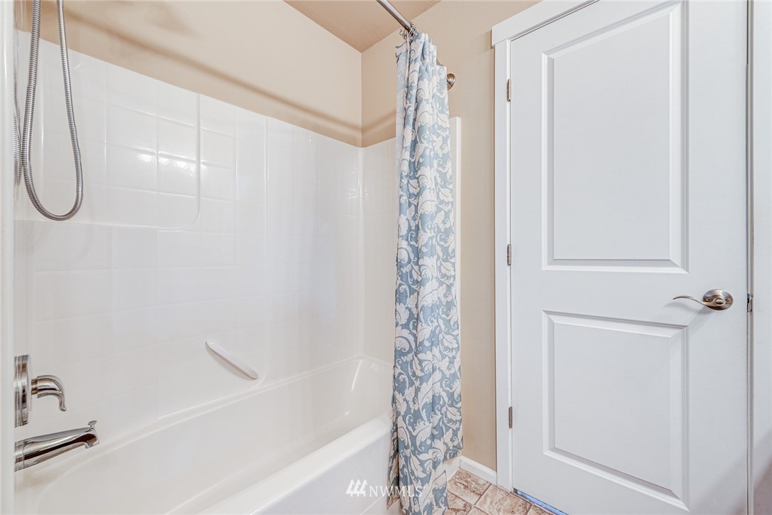 919 228th Street Southeast Bothell, WA 98021 - Photo 21 of 25 a bathroom with a shower curtain and a window