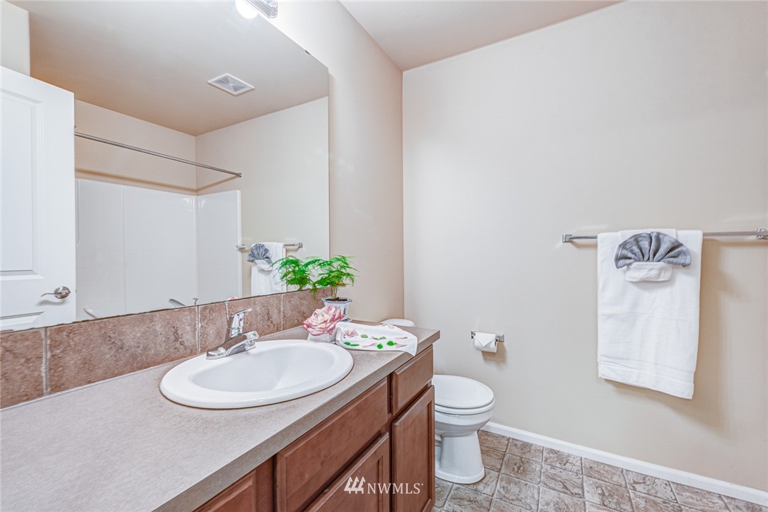 919 228th Street Southeast Bothell, WA 98021 - Photo 24 of 25 a bathroom with a toilet sink and mirror