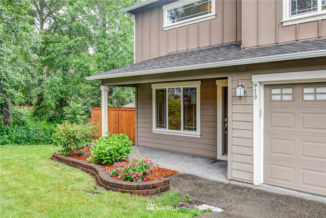 919 228th Street Southeast Bothell, WA 98021 - Photo 4 of 25 a front view of a house with a garden and plants