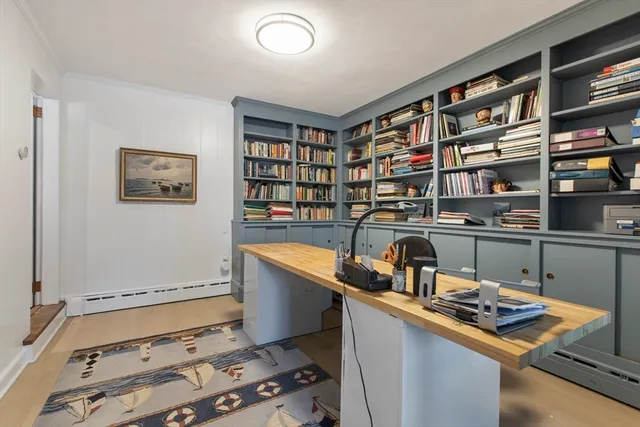 a room with a bookshelf and a table chair