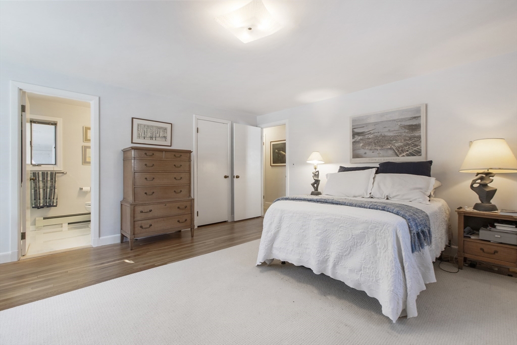 155 Paulson Road Newton, MA 02468 - Photo 15 of 33 a spacious bedroom with a bed and a lamp