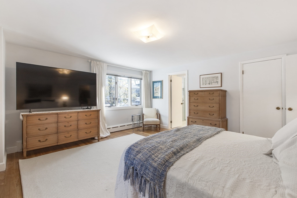 155 Paulson Road Newton, MA 02468 - Photo 17 of 33 a bedroom with a bed and a flat screen tv