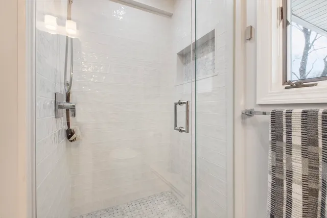 a living room with furniture a desk and a flat screen tv