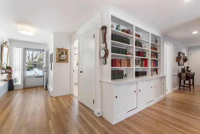 a view of kitchen with wooden floor and white cabinets