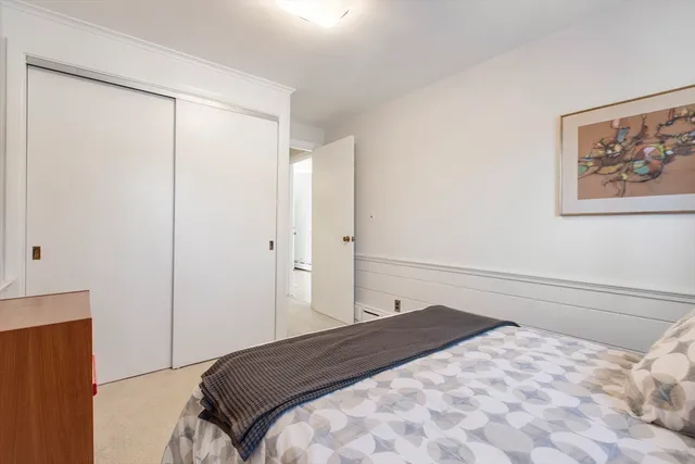 a bedroom with a bed and a large window