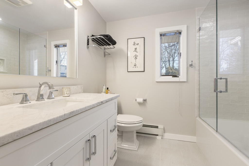 155 Paulson Road Newton, MA 02468 - Photo 26 of 33 a bathroom with a granite countertop sink mirror vanity and toilet