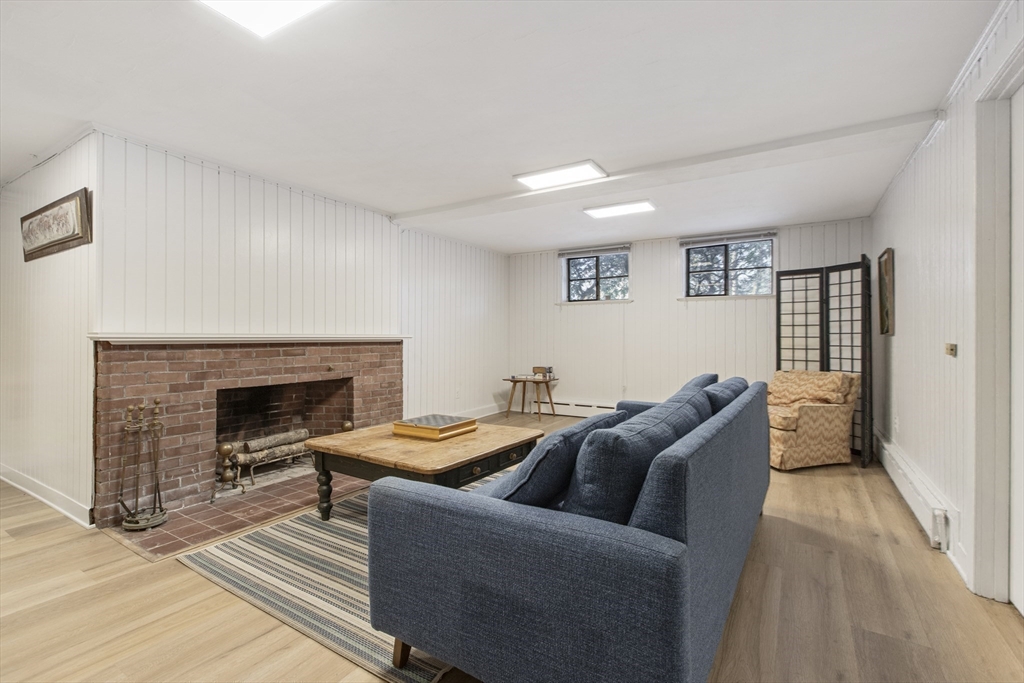 155 Paulson Road Newton, MA 02468 - Photo 28 of 33 a living room with furniture and a fireplace