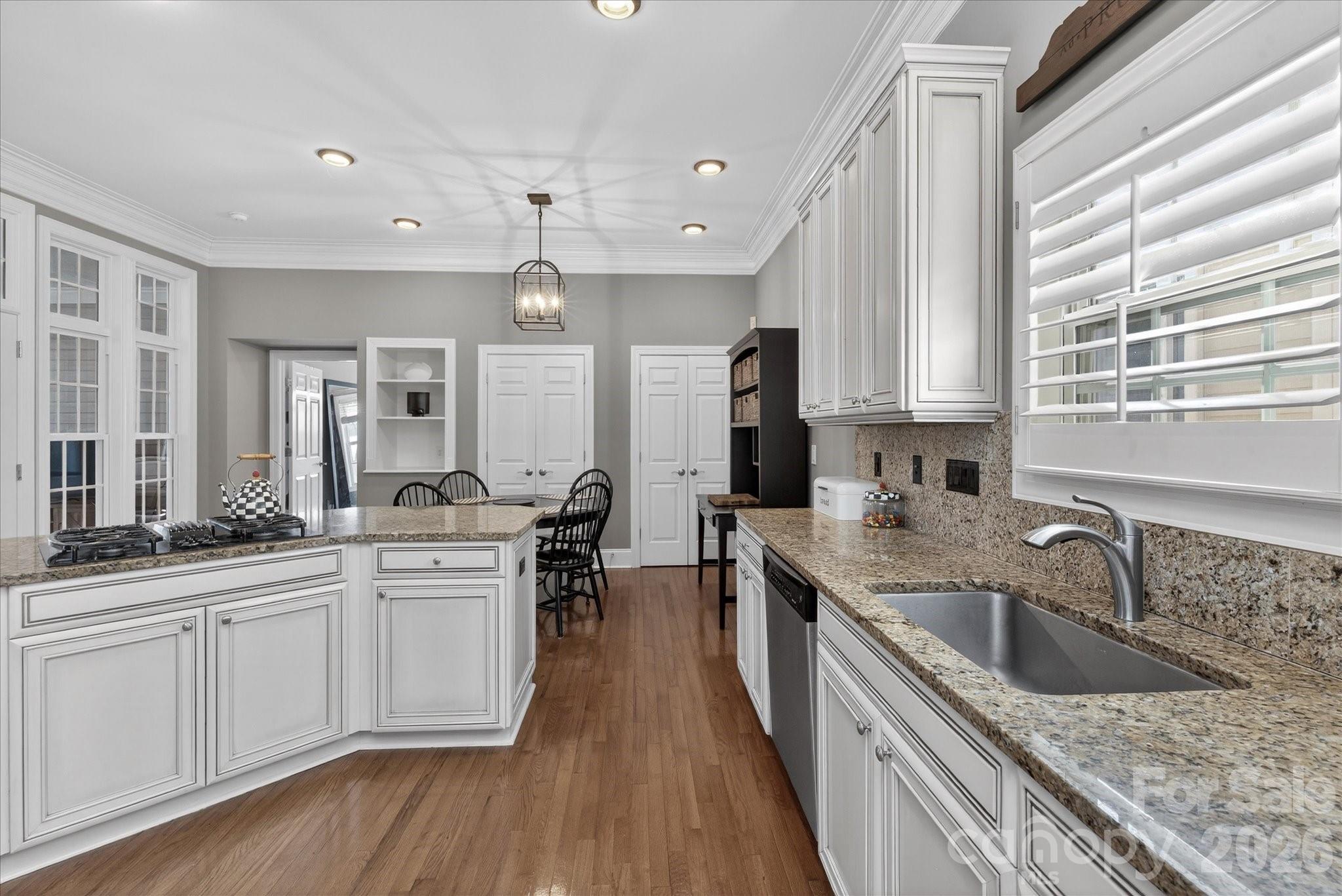 8811 1st Bloom Road Charlotte, NC 28277 - Photo 12 of 48 a kitchen with white cabinets sink and stainless steel appliances