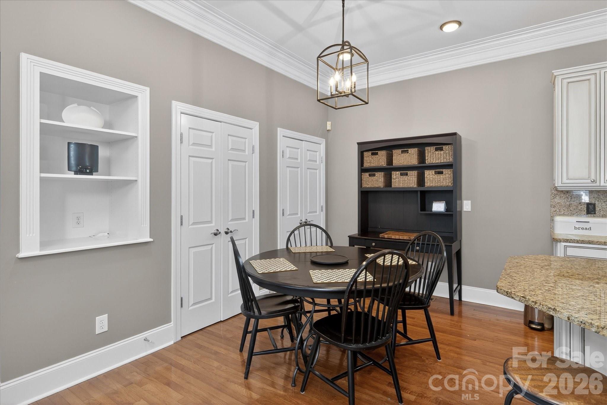 8811 1st Bloom Road Charlotte, NC 28277 - Photo 18 of 48 a view of a dining room with furniture and chandelier