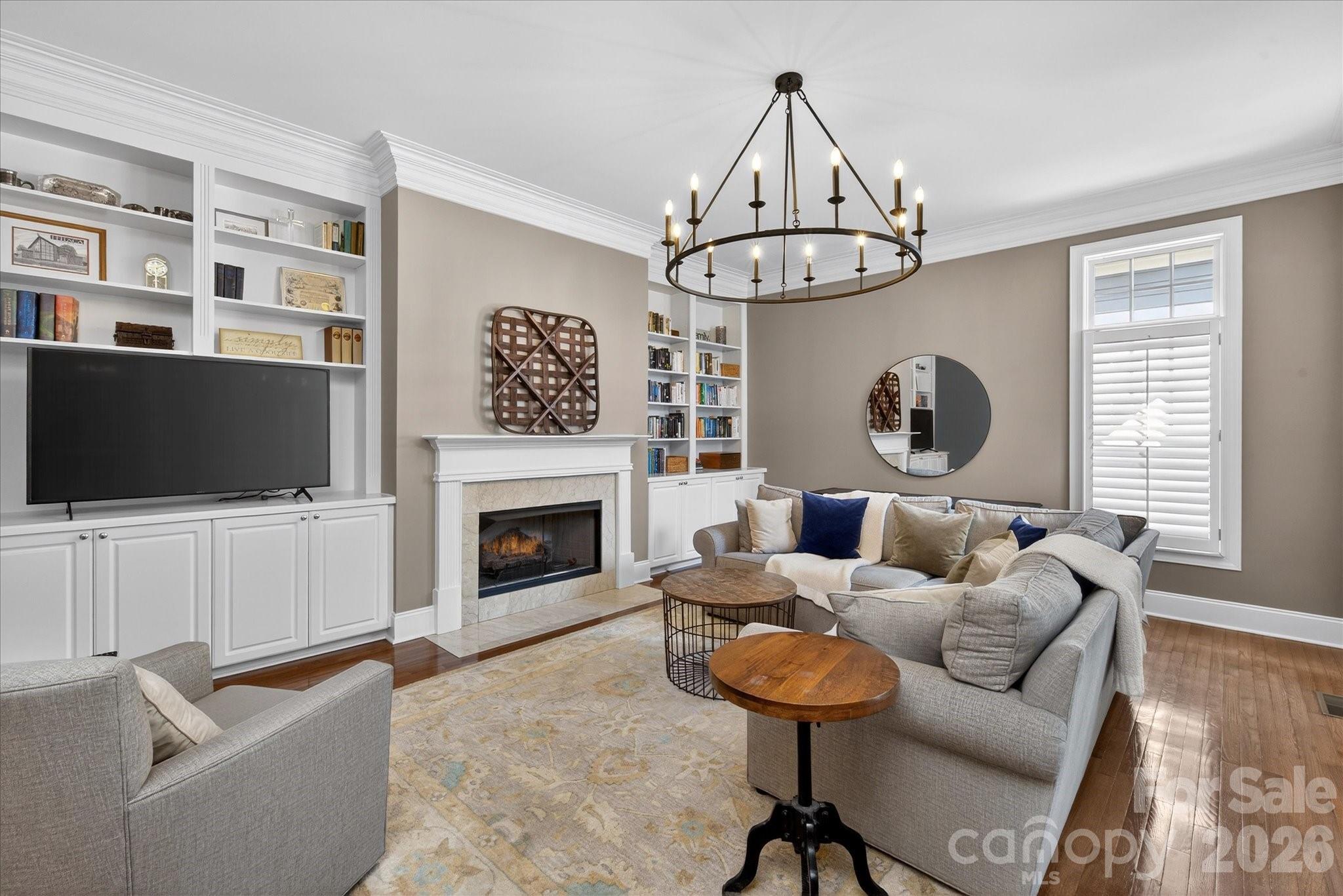 8811 1st Bloom Road Charlotte, NC 28277 - Photo 22 of 48 a living room with furniture a flat screen tv and a fireplace