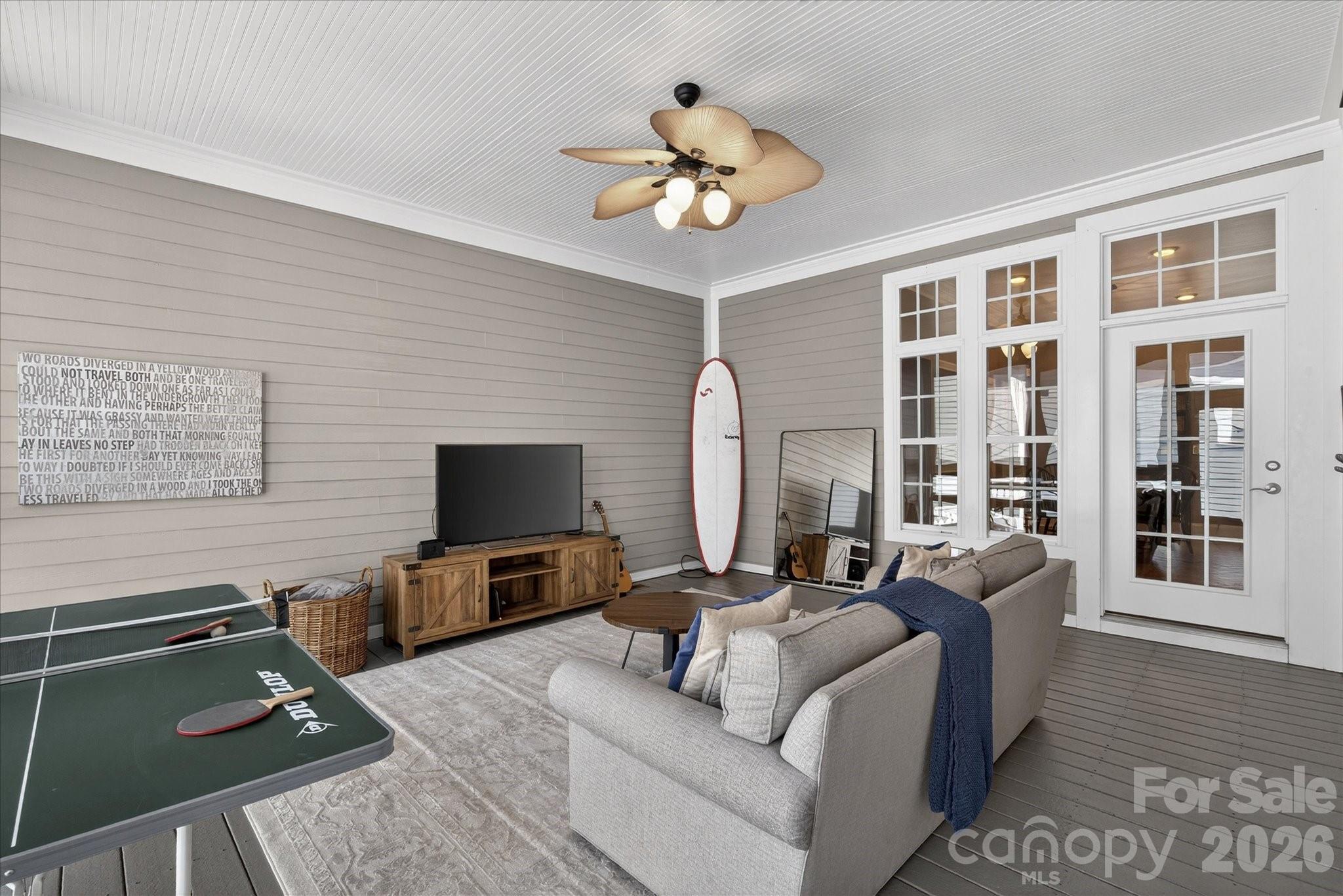 8811 1st Bloom Road Charlotte, NC 28277 - Photo 25 of 48 a living room with furniture a chandelier and a flat screen tv