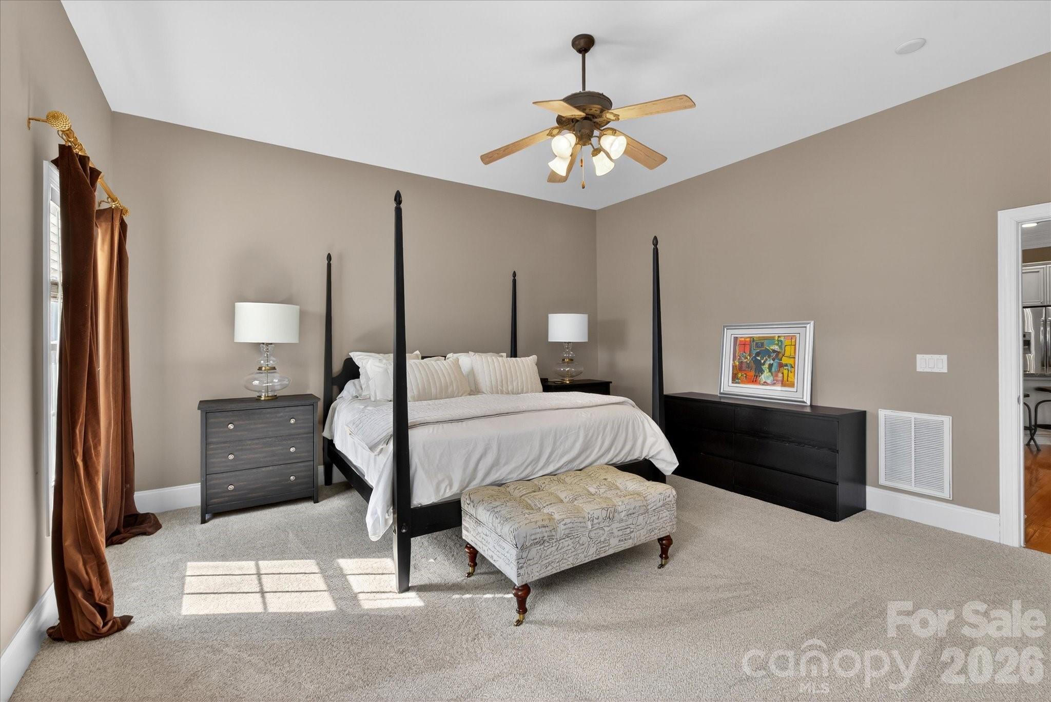 8811 1st Bloom Road Charlotte, NC 28277 - Photo 28 of 48 a bedroom with a bed and a chandelier