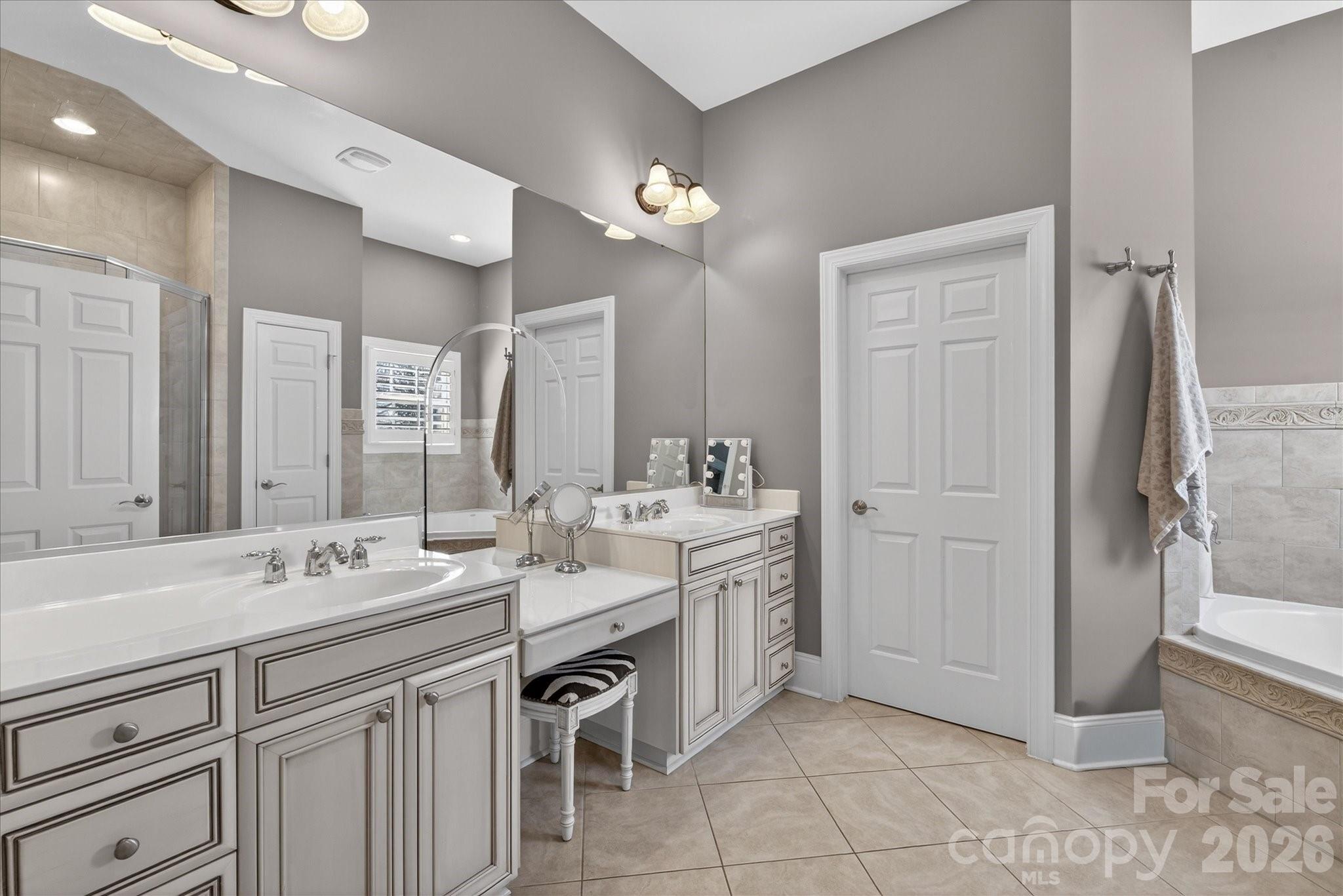 8811 1st Bloom Road Charlotte, NC 28277 - Photo 29 of 48 a spacious bathroom with a double vanity sink a mirror and a