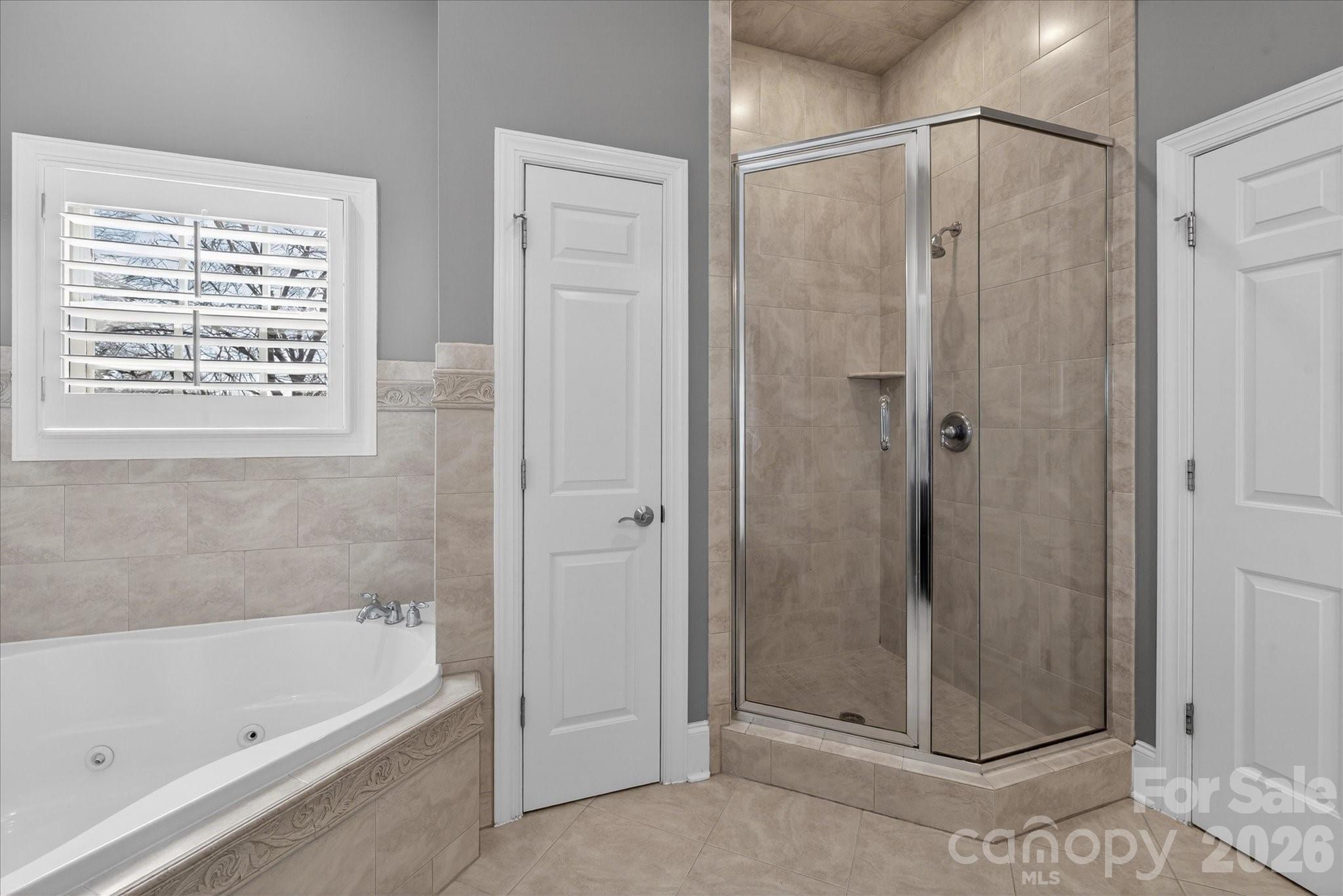 8811 1st Bloom Road Charlotte, NC 28277 - Photo 31 of 48 a bathroom with a bathtub and a shower