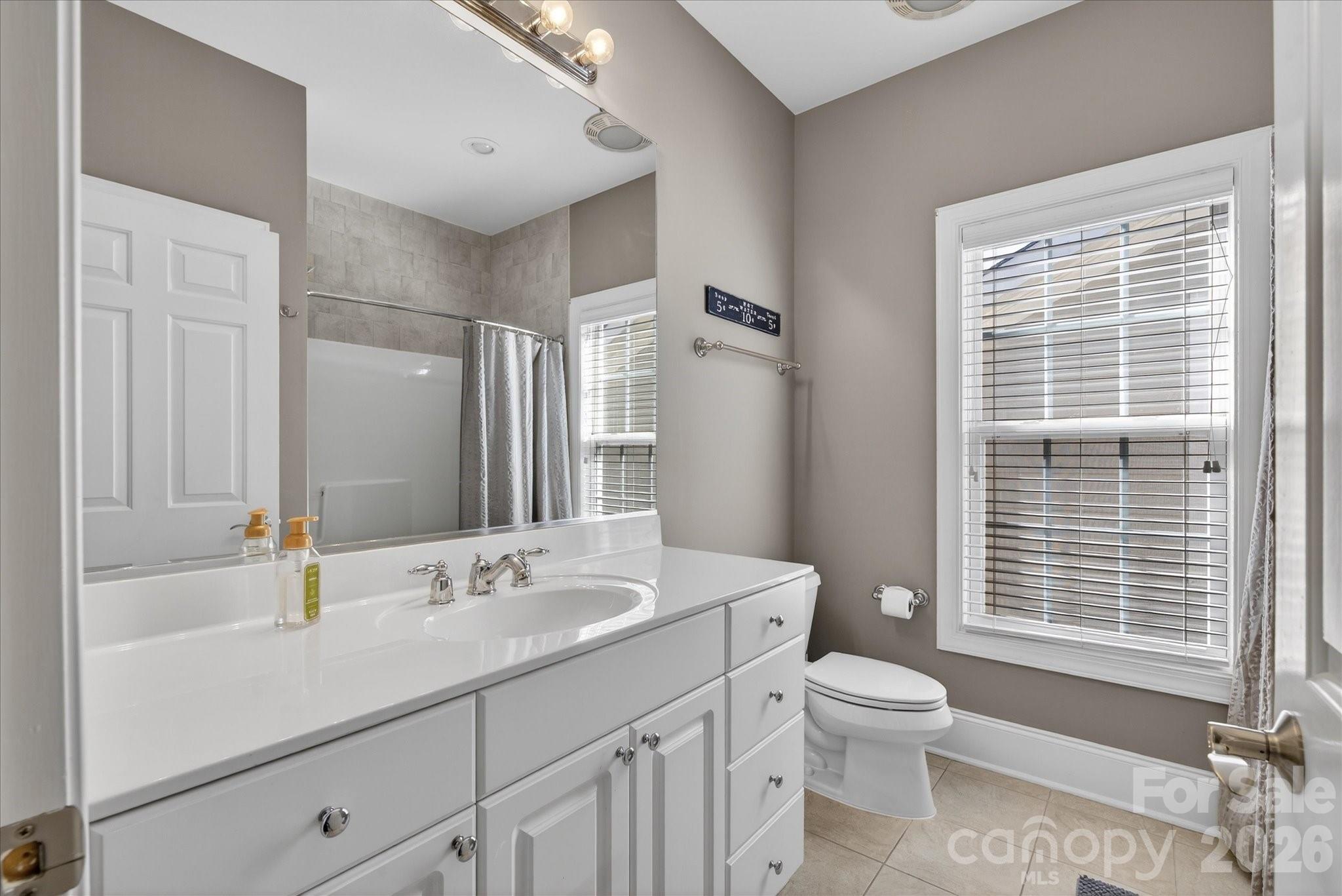 8811 1st Bloom Road Charlotte, NC 28277 - Photo 38 of 48 a bathroom with a sink a toilet and shower