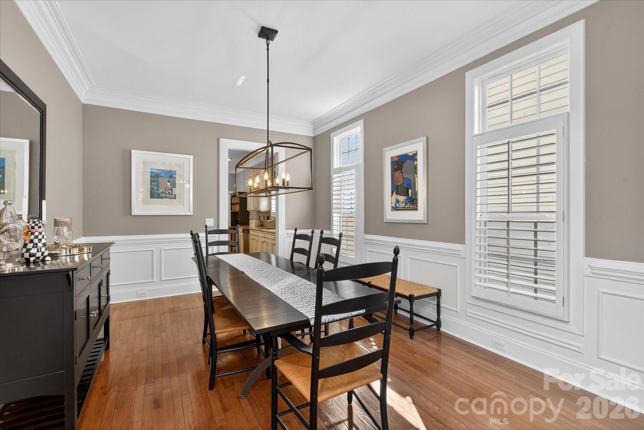 8811 1st Bloom Road Charlotte, NC 28277 - Photo 10 of 48 a dining room with furniture a chandelier and wooden floor