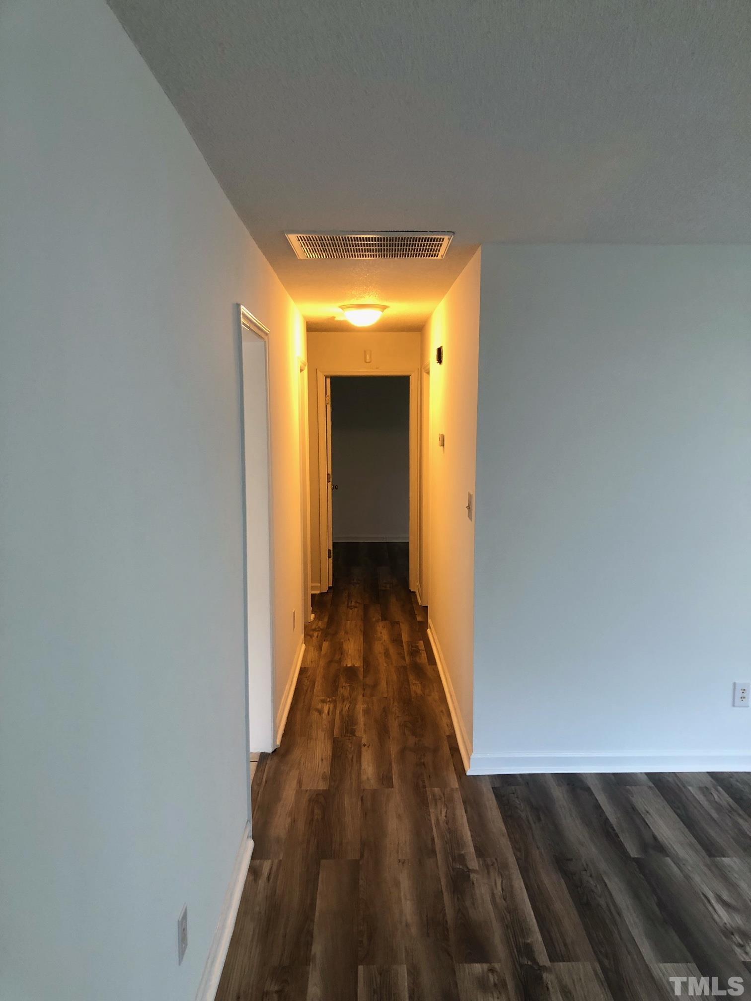 2103 Collier Road Durham, NC 27707 - Photo 11 of 23 a view of a hallway with wooden floor