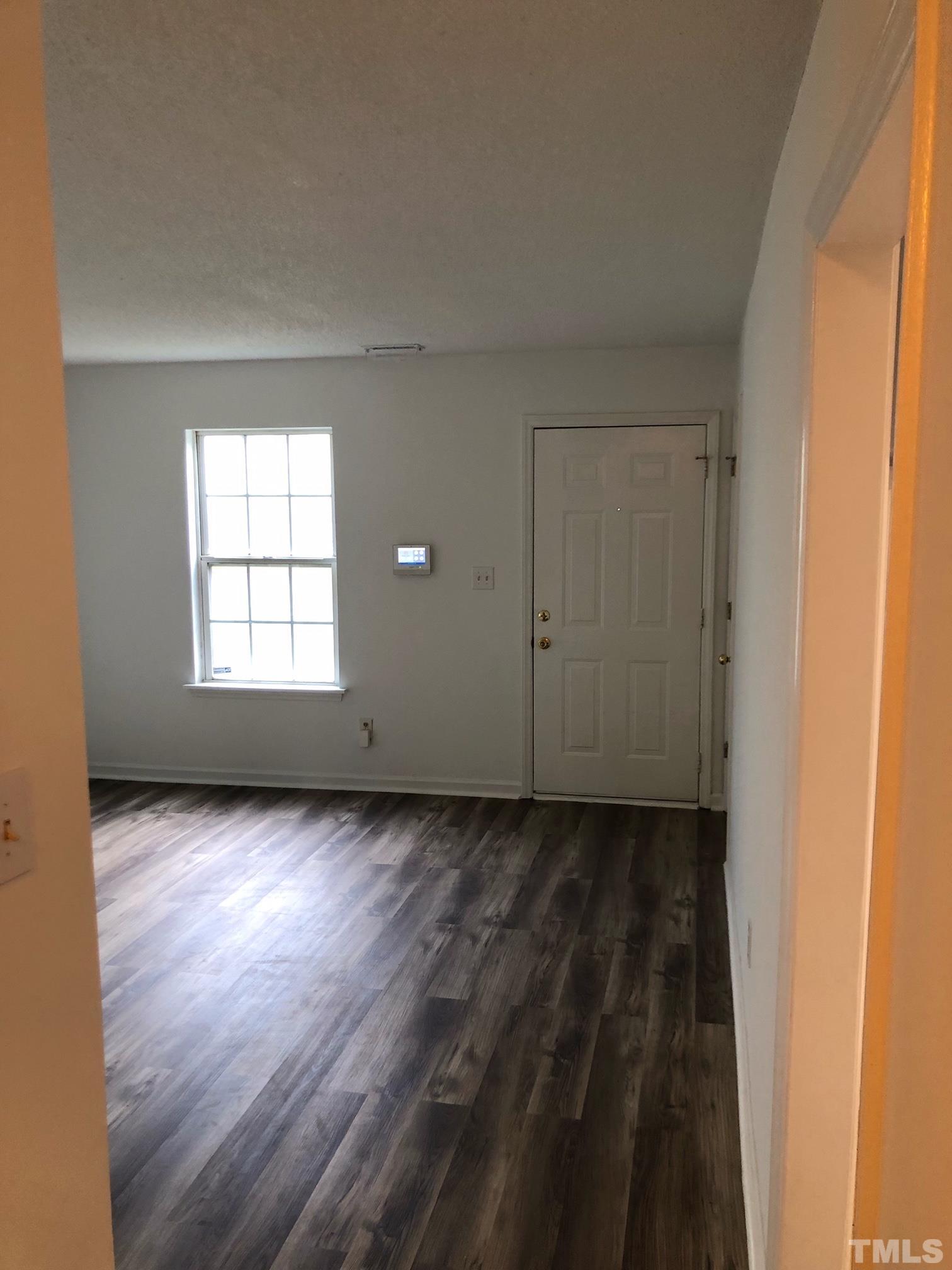 2103 Collier Road Durham, NC 27707 - Photo 12 of 23 an empty room with wooden floor and windows