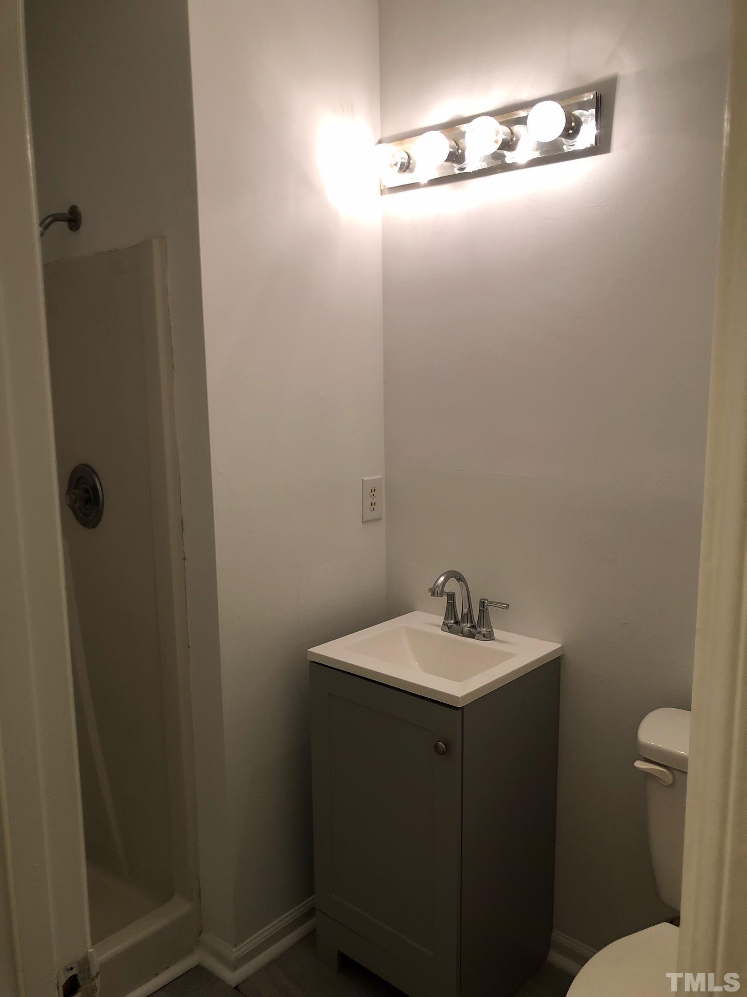 2103 Collier Road Durham, NC 27707 - Photo 14 of 23 a bathroom with a sink and mirror
