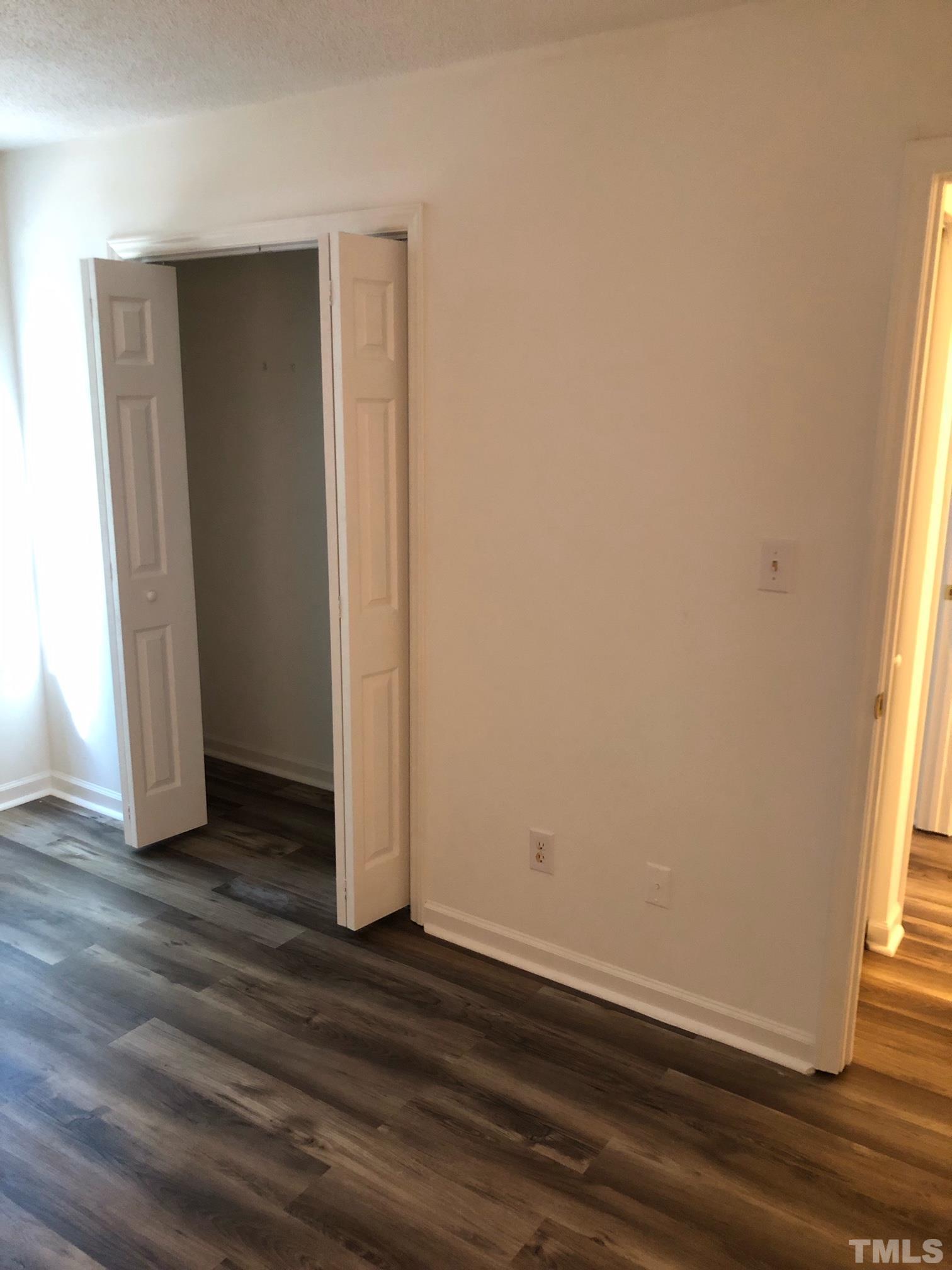 2103 Collier Road Durham, NC 27707 - Photo 18 of 23 an empty room with wooden floor and windows